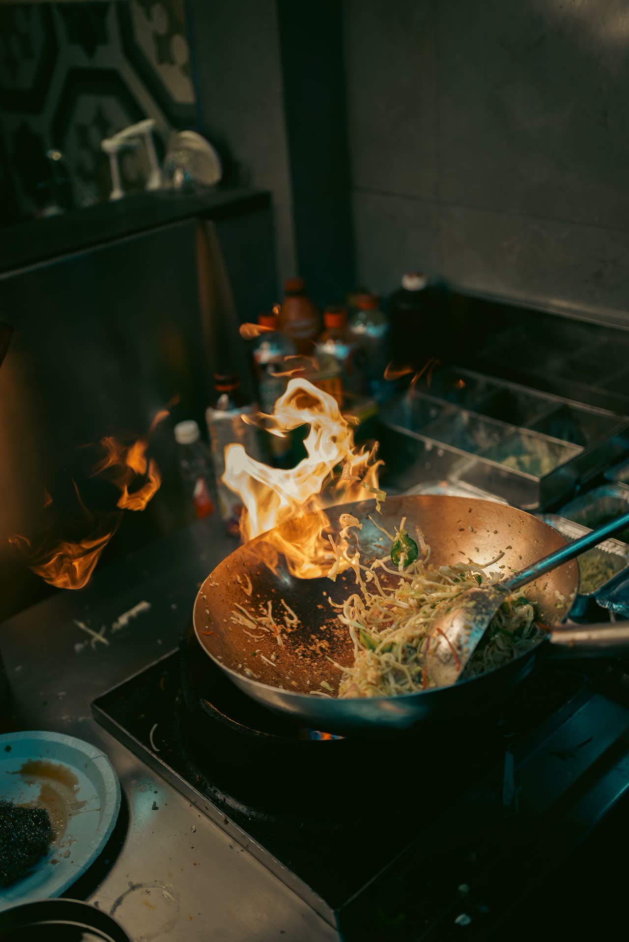 Noodles tossed over flame